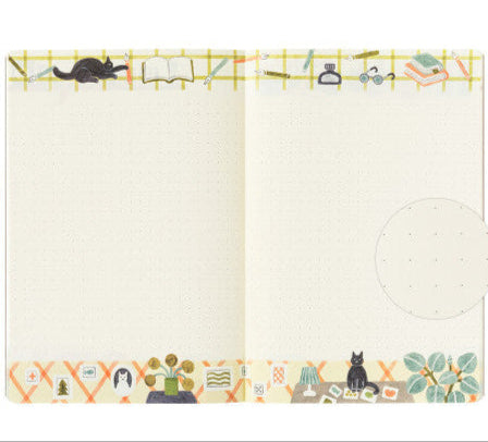 Open notebook with decorative page edges featuring illustrations of books, cats, and other elements.