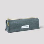 Blue pencil case with a gold zipper on a light gray background