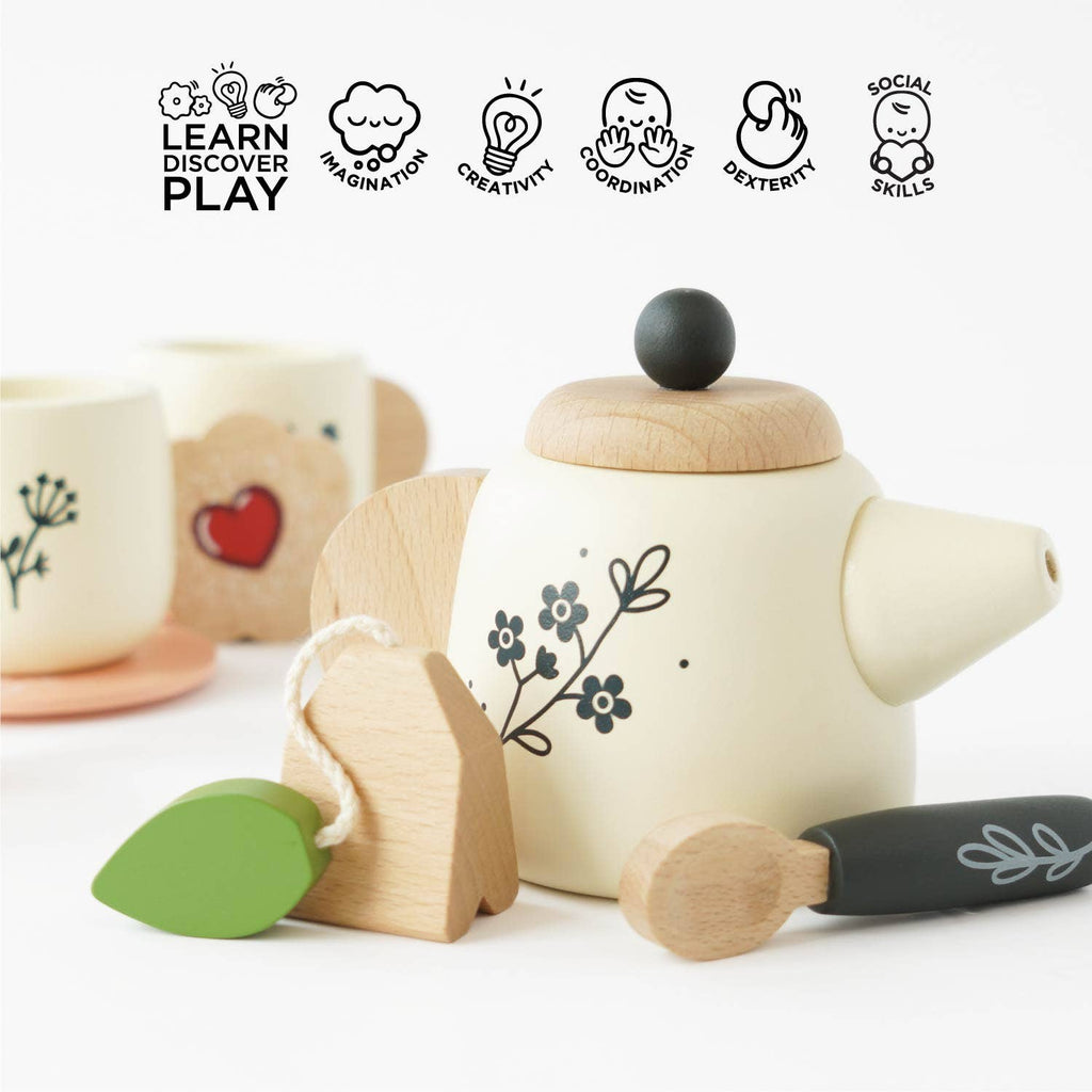 Wooden toy teapot with decorative elements on a white background, featuring icons and text about learning, discovery, and play.