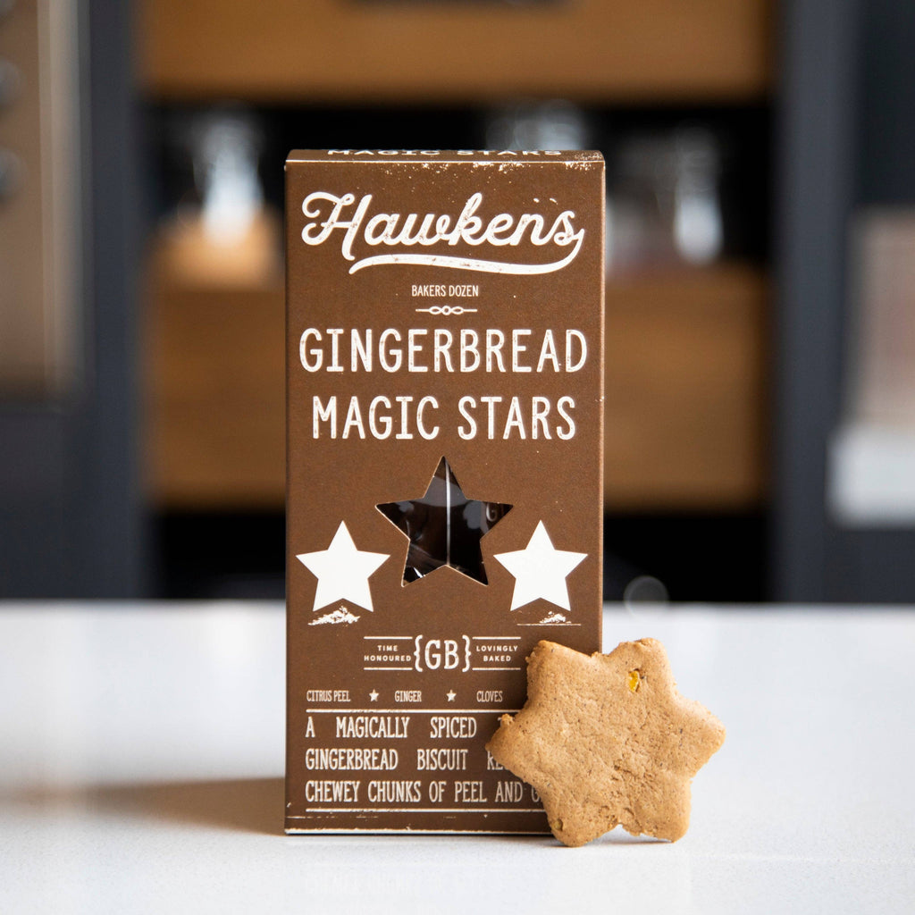 Box of Hawken's Gingerbread Magic Stars with a star-shaped cookie on a kitchen counter.