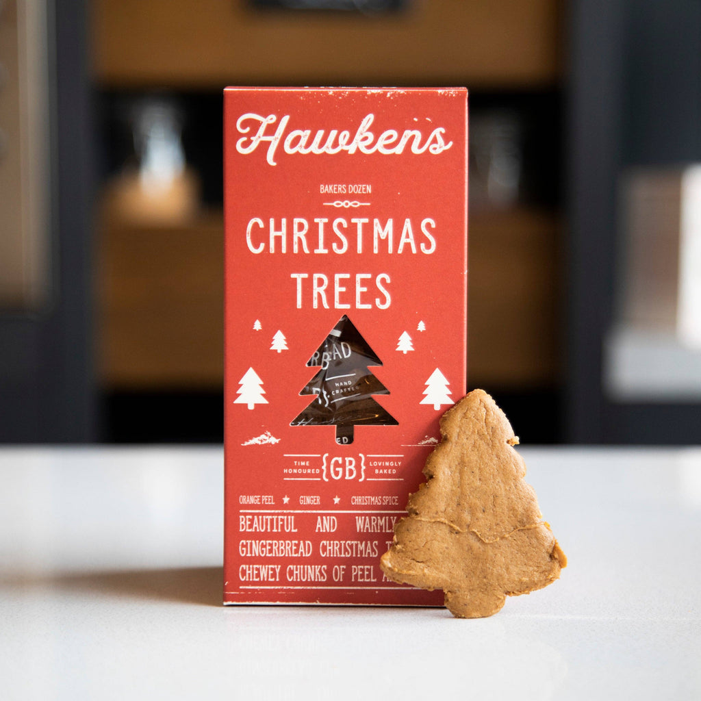 Red box of Hawken's Christmas Trees on a white surface with a blurred background