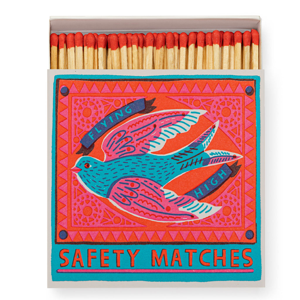 Luxury boxed matches by Archivist Gallery, featuring a soaring bird in shades of pink, red and blue 