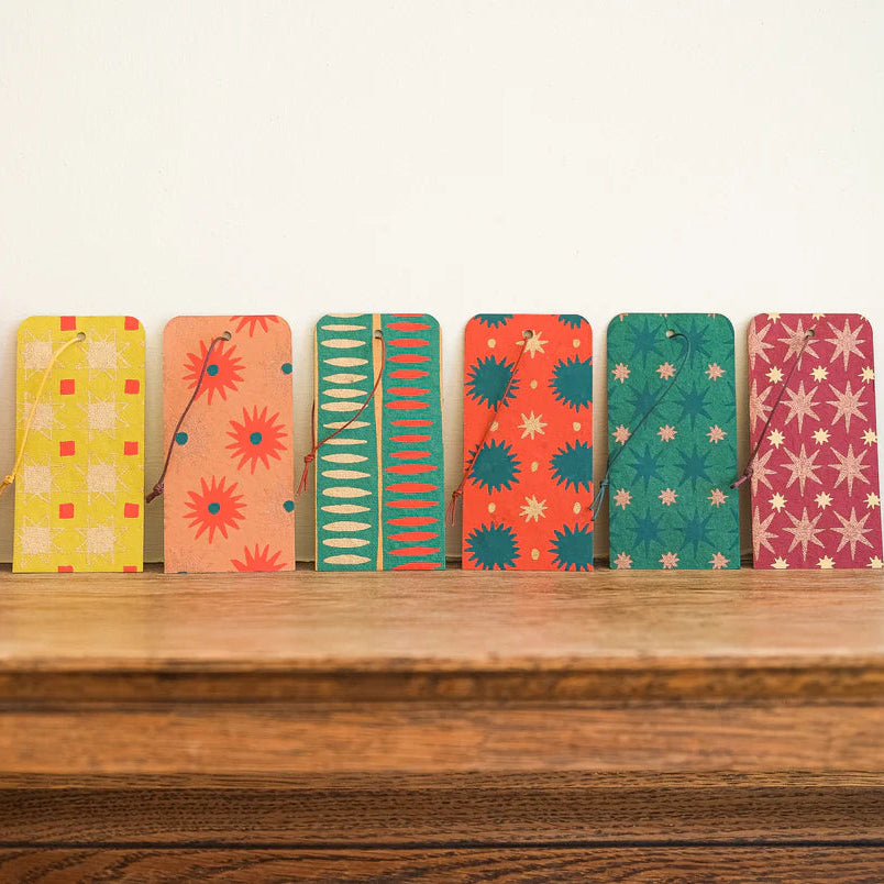 Colorful gift tags on a wooden shelf with a white background