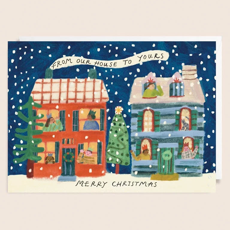 Christmas card with two houses, trees, and people on a snowy night.