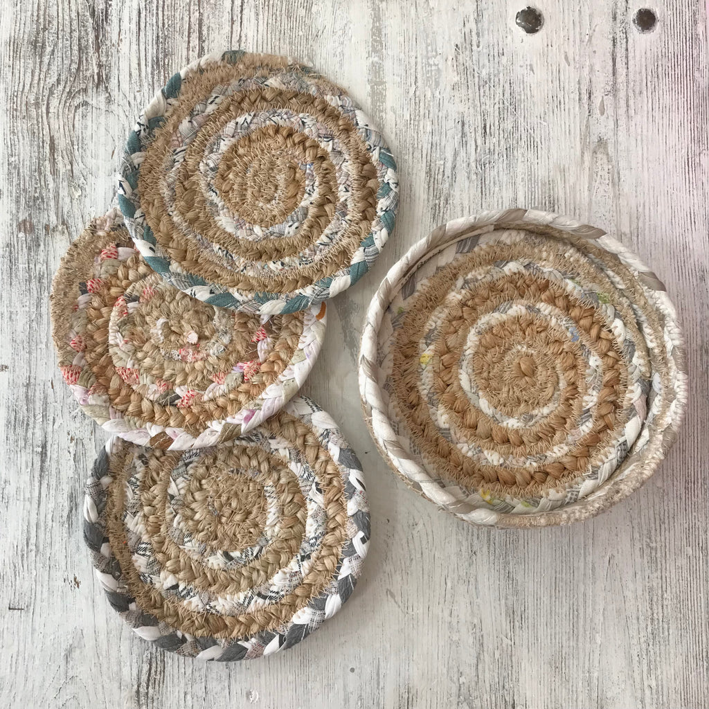 Set of six organic Woven Jute Coasters in neutral tones, packed in a jute basket.