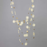 Decorative garland with star-shaped white paper and gold circles on a gray background