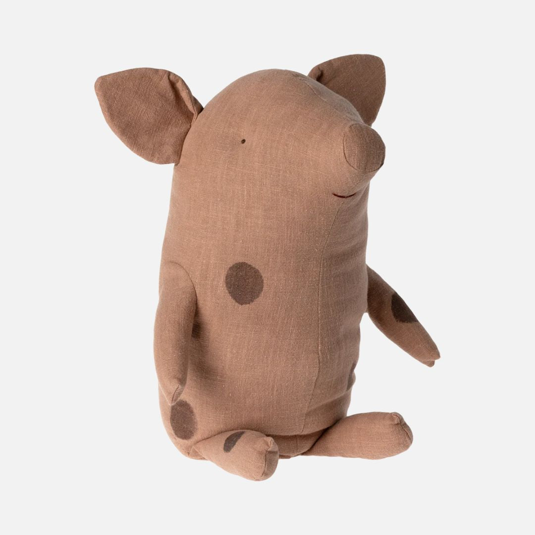 Spotty plush pig toy on a white background