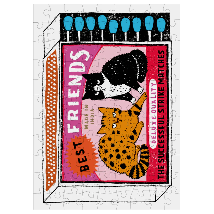 Jigsaw puzzle with a design of two cats on a matchbox labeled 'Friends' on a white background.