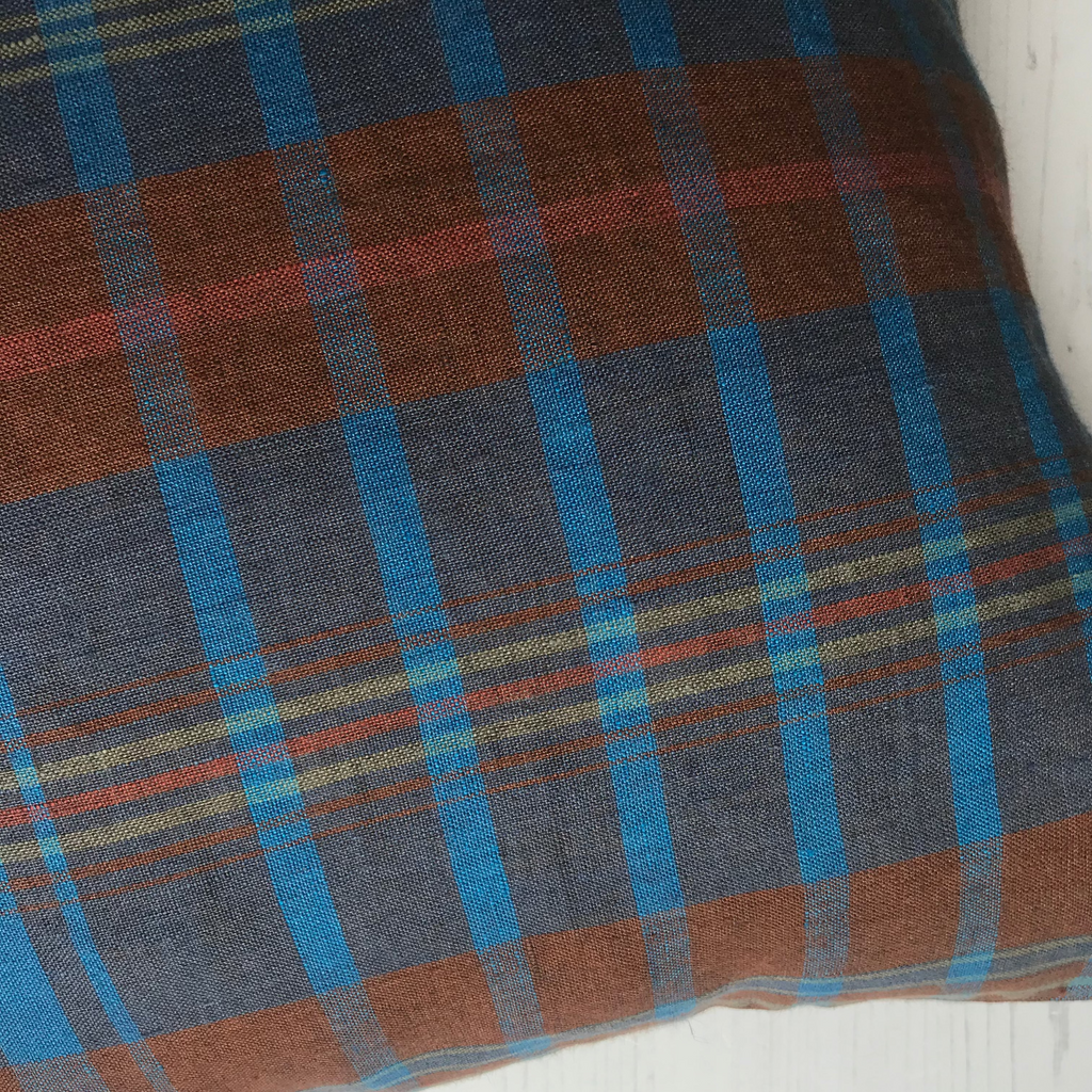 Plaid fabric with blue and brown pattern on a white background