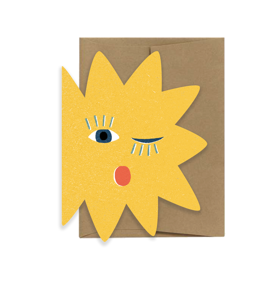 Card with a yellow sun design featuring eyes and a mouth on a brown envelope.