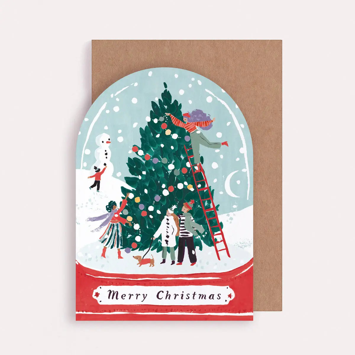 Christmas card with illustration of people decorating a tree, inside a snow globe, on a brown envelope.
