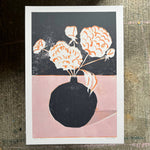 Art print of a black vase with white flowers on a dark background