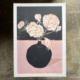 Art print of a black vase with white flowers on a dark background