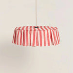Red and pale pink striped pendant light on a beige background