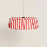 Red and pale pink striped pendant light on a beige background