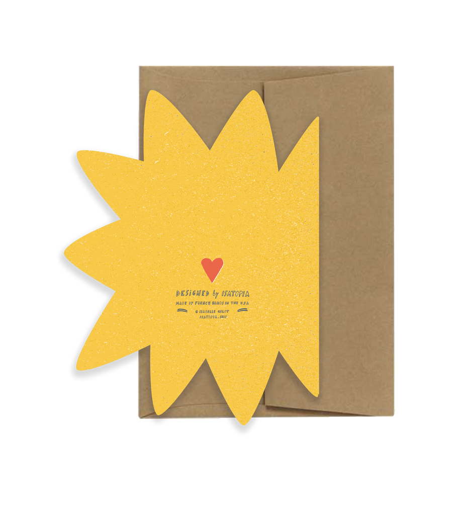 Card with yellow sun design and brown envelope on a white background