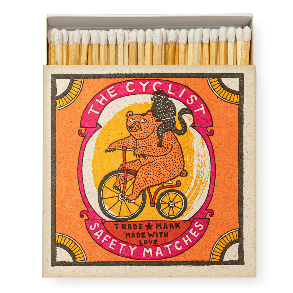 Luxury boxed matches by Archivist Gallery, featuring an illustrated design of a bear riding a penny farthing, by artist Charlotte Farmer.